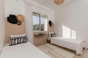 Ένα ή περισσότερα κρεβάτια σε δωμάτιο στο Joli appartement de Vacances à Imi Ouaddar +32 φωτογραφίες