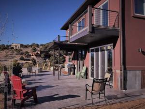 a group of chairs sitting outside of a building at Barnwood Chateau With 2 Master Suites Hot Tub in Salida