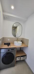 a bathroom with a sink and a mirror at L'écume du fort , Face à la mer, Coucher de soleil in Le Portel