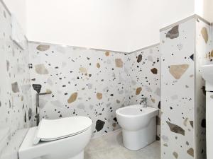 a bathroom with a toilet and a sink at Residence Mario Bianco in Milan