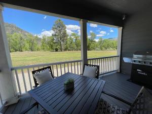 a porch with a table and chairs and a grill at 2Bed2Bath with Creek and Open Spaces in Durango