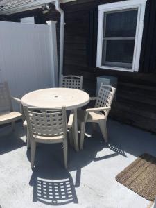 a white table and chairs on a patio at 111-5 Glendon Beach Condo in Dennis Port +11 photos