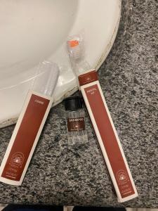 two beauty products sitting on top of a counter at Elite 5BR Escape Home Theater,BBQ,Rooftop Scenic Hills in Naka +92 photos