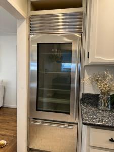 a stainless steel refrigerator in a kitchen at Modern Home with Full Gym & Personal garden in San Jose