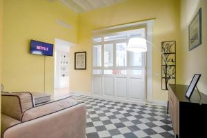 a living room with a couch and a door at Elegantis Monti Royal Apartment with private terrace in Rome
