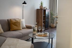 a living room with a couch and a table with wine glasses at Wohnkultur - Altbau Charme für 8 Personen in Mannheim +31 photos