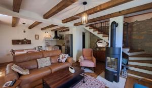 a living room with a couch and a fireplace at ISTRIAN vibeS in Drenje
