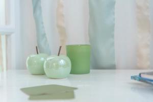 three green apples sitting on a table with a cup at 5 steps from the sea in Kalamata +52 photos