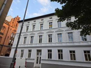 a white building with many windows on a street at Apartament przy Poczcie in Koszalin