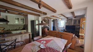 a kitchen and a dining room with a table and a kitchen at ISTRIAN vibeS in Drenje