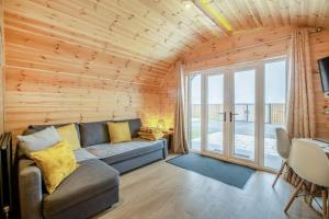 a living room with a couch and a large window at Hugo in East Cowton
