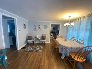 ein Esszimmer und ein Wohnzimmer mit Tisch und Stühlen in der Unterkunft Willows Cottage West in Dennis Port + 2 Fotos