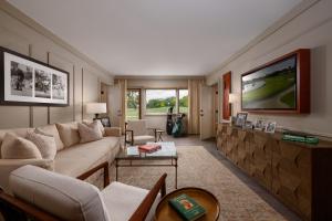 a living room with a couch and a tv at Arnold Palmer's Bay Hill Club & Lodge in Orlando