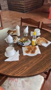 een houten tafel met borden en eten erop bij Costa del sol Termas Ex Lucas III in Termas de Río Hondo +5 foto's