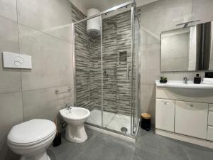 a bathroom with a shower and a toilet and a sink at La Viuzza Rooms in Barletta