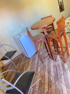 a table and chairs sitting in a room at Hotel Pousada Mozini's in Tupã