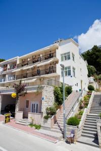 a large building with stairs in front of it at Apartments Nikola in Baška Voda