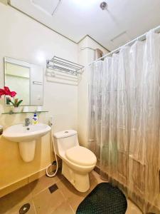 a bathroom with a white toilet and a sink at Condo at the Heart of Davao in Avida Towers Davao in Davao City