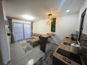 a kitchen and living room with a couch and a table at Etno Lux Isaković in Ulcinj