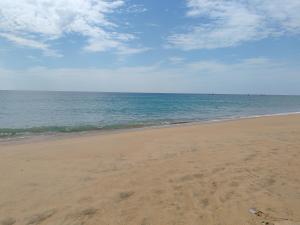 an empty beach with the ocean in the background at Ss room villa in Kattankudi +23 photos