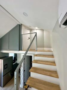 a staircase in a house with white walls and wooden floors at Tiny Private Room #2 in Shared 5BR House with Other Guests in Austin