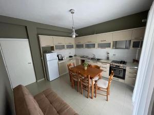 a kitchen with a table and chairs and a couch at Casa Di SI in Përmet