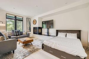 a bedroom with a king sized bed and a couch at River West 822 in Silverthorne