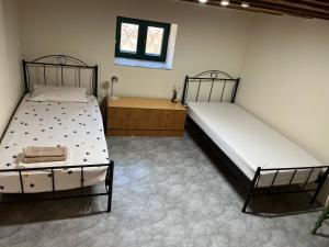 a bedroom with two beds and a dresser at Sunshine 1 in Leonidio