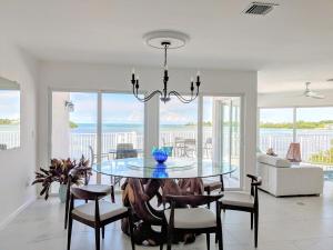 a dining room with a glass table and chairs at Ocean Dream in Marathon