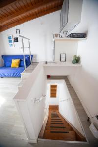 a white staircase in a room with a bed at Duplex San Fedele in Como