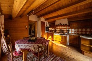 a kitchen with a table and a kitchen with wooden ceilings at Beauregard Jura - Peaceful Estate Stays Near Geneva in Gex