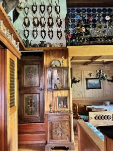 a kitchen with wooden cabinets and plates on the wall at Attico Cortina D'Ampezzo in Cortina dʼAmpezzo +12 photos