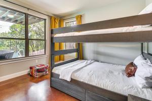 a bedroom with two bunk beds and a window at Lake Travis House with Private Dock, Pool and Hot Tub! in Leander +36 photos