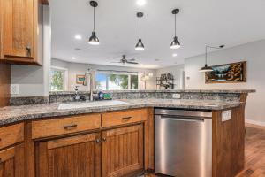 a kitchen with wooden cabinets and a stainless steel dishwasher at Bear Lake Bliss in Bear Lake