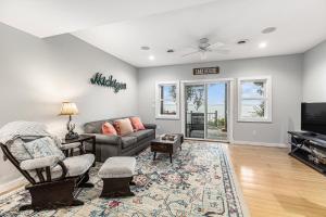 a living room with a couch and a tv at Bear Lake Bliss in Bear Lake