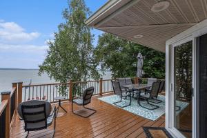 a wooden deck with a table and chairs on it at Bear Lake Bliss in Bear Lake