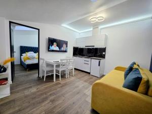 a living room with a couch and a dining room at Family House Deva in Deva