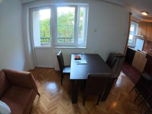 a dining room with a table and chairs and a window at Roomer Prishtina Hostel in Prishtinë