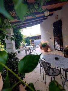a patio with tables and chairs on a patio at Agriturismo la Canonica in Manciano +36 photos