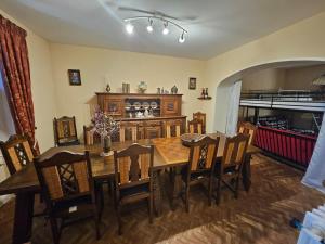 a dining room with a wooden table and chairs at Gite du menuisier in Saint-Georges-de-Mons