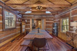 a table in a room with wooden walls and wooden floors at Cricket Hollow Lodge in Jenkins Mill