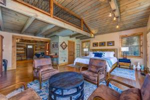 a bedroom with a bed and a table and chairs at Cricket Hollow Lodge in Jenkins Mill +33 photos