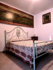 a bedroom with a bed with a metal frame at Agriturismo la Canonica in Manciano