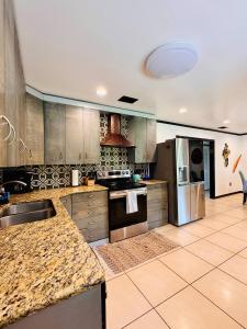 a large kitchen with stainless steel appliances and granite counter tops at Luxury Home -Sleeps 8- Pet OK- St. Cloud - Orlando in Saint Cloud