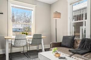 a living room with a couch and a table with chairs at The Metropolitan Manor-new Corporate Apt Downtown in Grand Rapids +11 photos