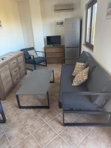 a living room with a couch and a table at Agriturismo Montealma in Nulvi