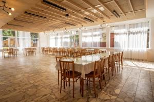 a large room with a long table and chairs at The Cabin Retreat Piešťany 