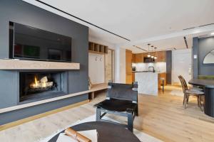 a living room with a fireplace and a dining room at Lodge Tower 486 Two Bedroom Residence in Vail