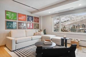 a living room with a white couch and a table at Lodge Tower 486 Two Bedroom Residence in Vail
