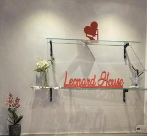 a glass shelf with a sign that reads normal lane at Leonard Chalet House in Albiano